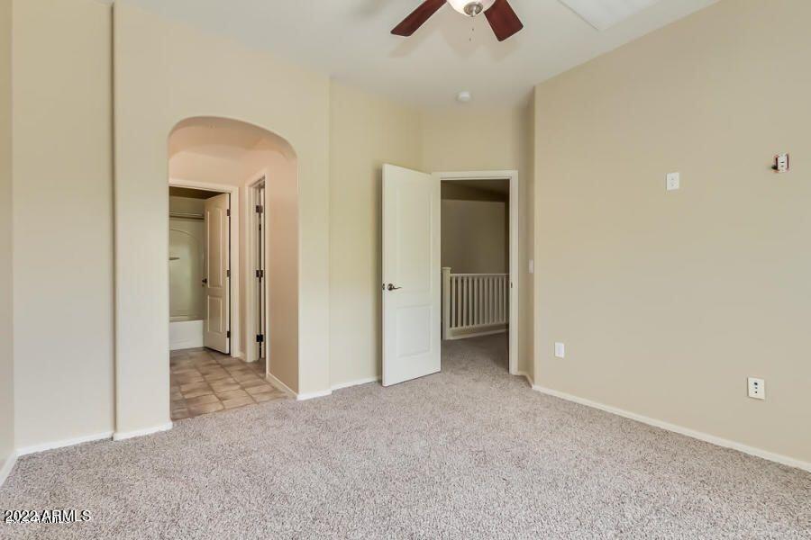 4750 East Thunderheart Trail, Unit 102 Gilbert, AZ 85297 - Photo 17 of 25 an empty room with closet and a chandelier fan