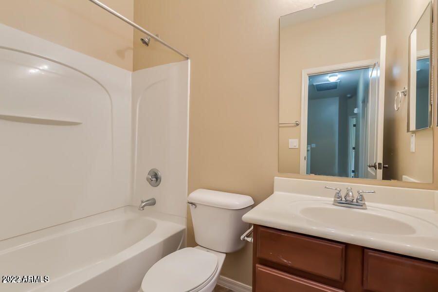 4750 East Thunderheart Trail, Unit 102 Gilbert, AZ 85297 - Photo 22 of 25 a bathroom with a sink toilet vanity and shower