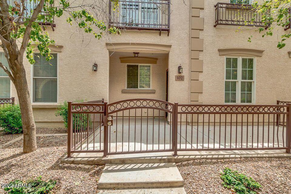 4750 East Thunderheart Trail, Unit 102 Gilbert, AZ 85297 - Photo 5 of 25 front view of a house with a iron gate