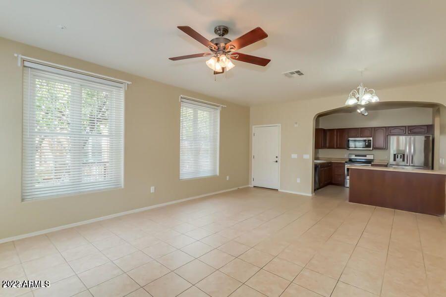 4750 East Thunderheart Trail, Unit 102 Gilbert, AZ 85297 - Photo 6 of 25 a view of an empty room with a kitchen