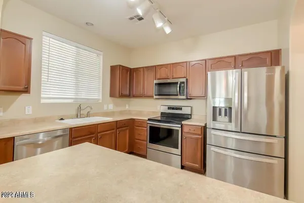 a kitchen with a sink stove and microwave