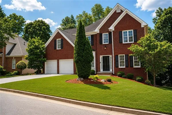 a front view of a house with a yard and garage