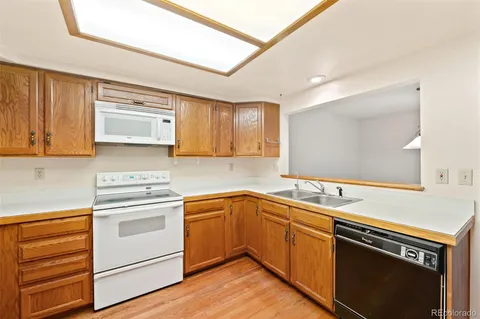 a kitchen with a sink stove and microwave