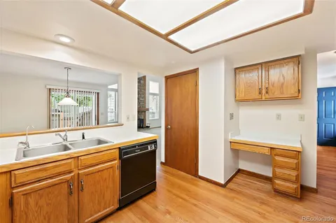 a kitchen with sink cabinets and wooden floor