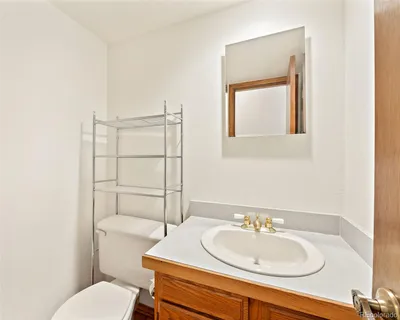 a bathroom with a sink toilet and mirror