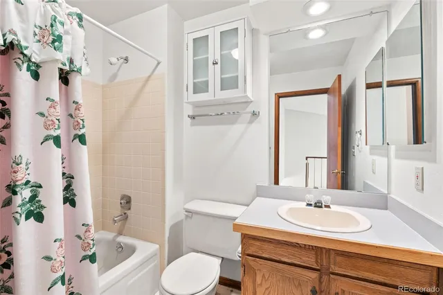 a bathroom with a sink vanity mirror and toilet