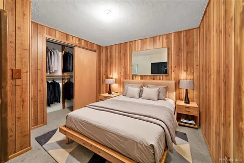 a bedroom with a bed and a flat tv screen