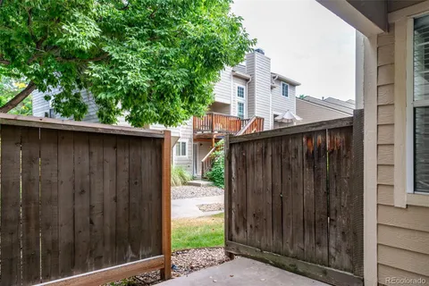 a view of a wooden door in front of house