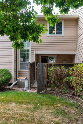 a view of a house with backyard and porch