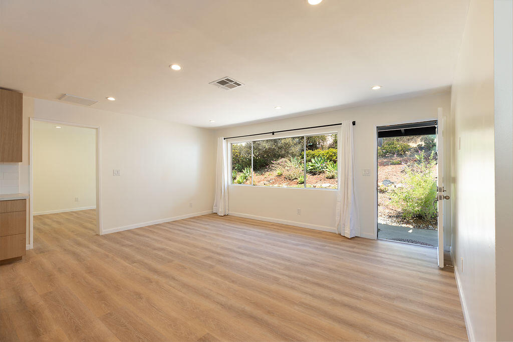 24 Pine Drive Santa Barbara, CA 93105 - Photo 11 of 45 an empty room with wooden floor and windows