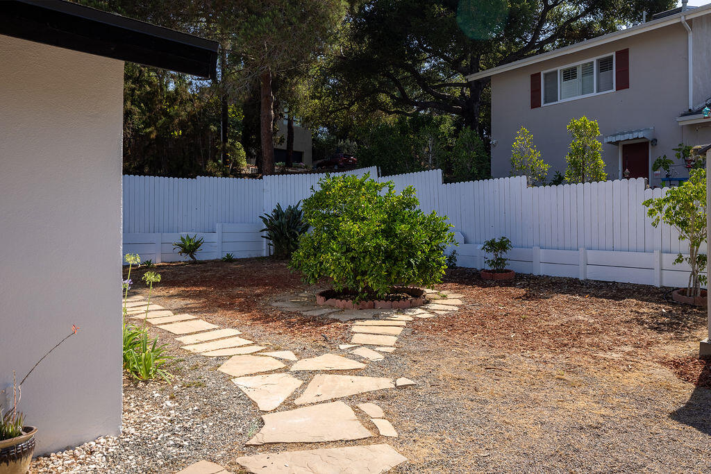 24 Pine Drive Santa Barbara, CA 93105 - Photo 38 of 45 a view of a backyard with potted plants and a wooden bench