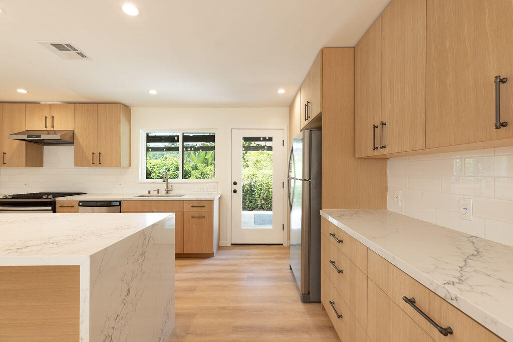 24 Pine Drive Santa Barbara, CA 93105 - Photo 5 of 45 a kitchen with a stove top oven sink and cabinets
