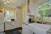 2313 Eccleston Street Silver Spring, MD 20902 - Photo 4 of 13 a kitchen with a window and cabinets