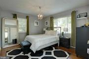 2313 Eccleston Street Silver Spring, MD 20902 - Photo 5 of 13 a bedroom with a bed and a mirror