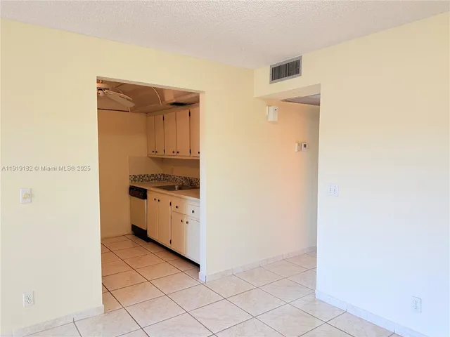 a utility room with cabinets washer and dryer