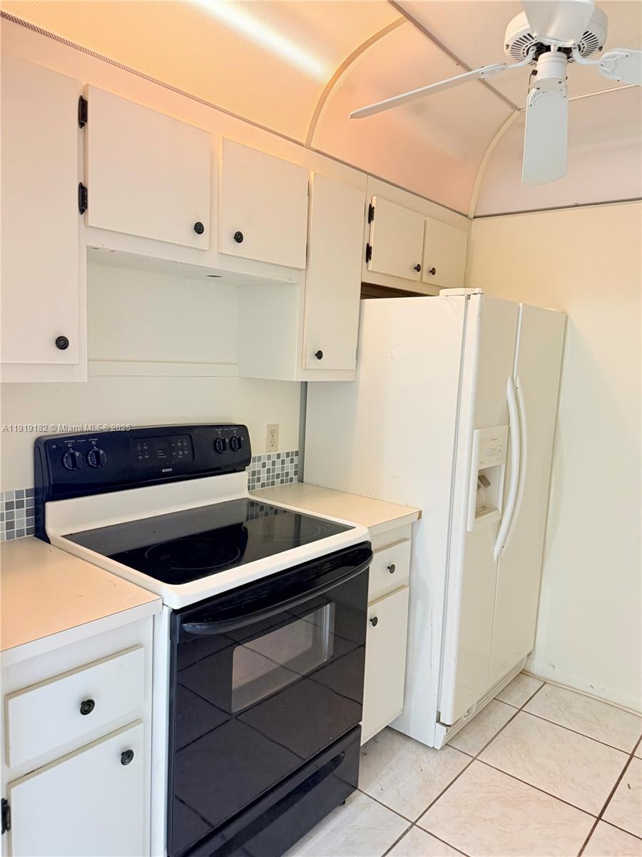 850 Southwest 133rd Terrace, Unit 416B Pembroke Pines, FL 33027 - Photo 6 of 13 a kitchen with a stove and a refrigerator