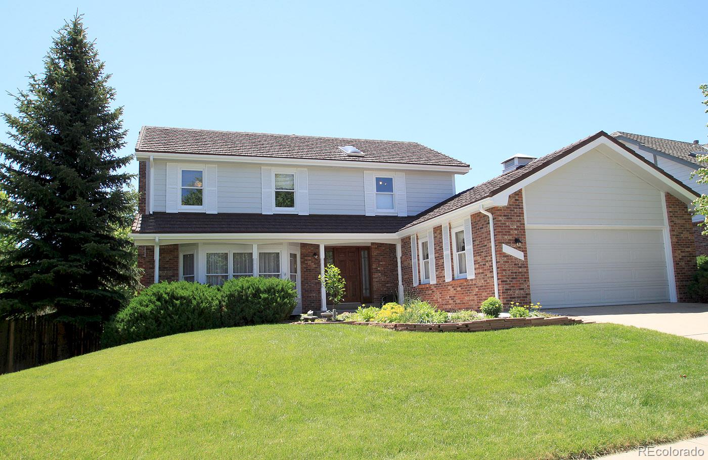 8198 Sweet Water Road Lone Tree, CO 80124 - Photo 1 of 23 a front view of house with yard and green space