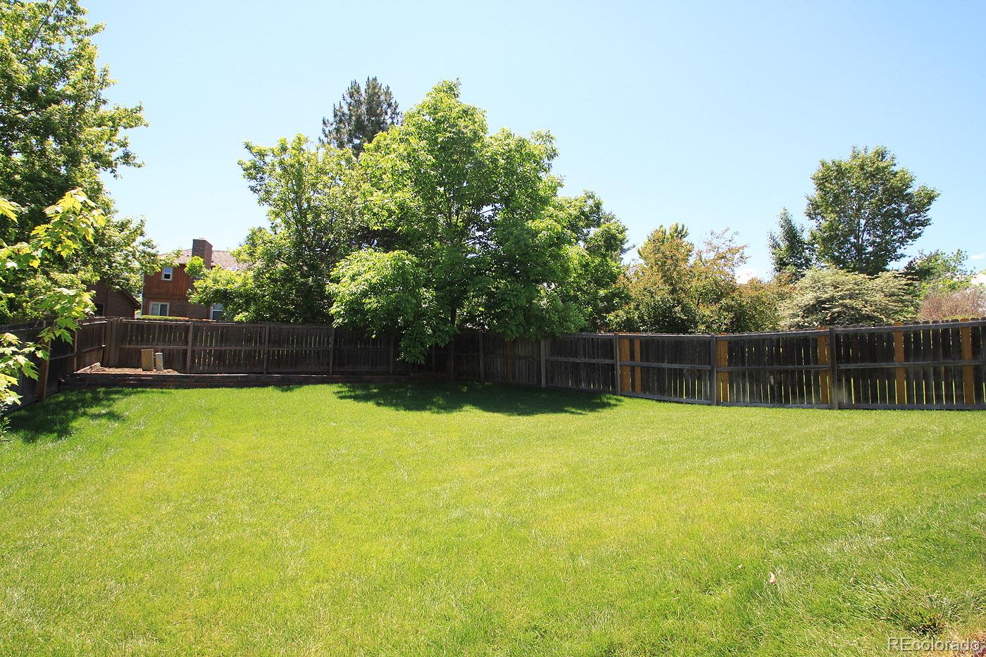 8198 Sweet Water Road Lone Tree, CO 80124 - Photo 22 of 23 a swimming pool with plants and trees