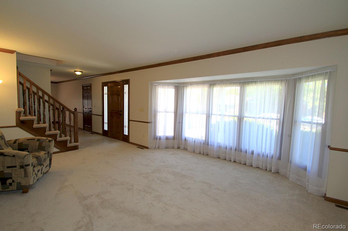 8198 Sweet Water Road Lone Tree, CO 80124 - Photo 4 of 23 a view of an empty room with windows