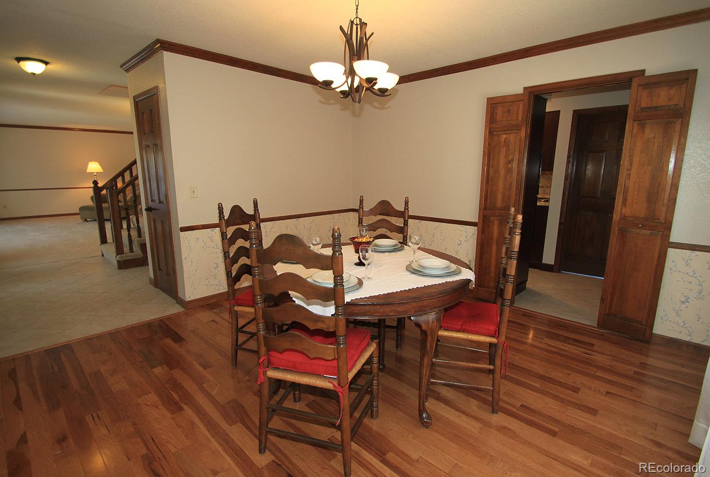 8198 Sweet Water Road Lone Tree, CO 80124 - Photo 6 of 23 a view of a dining room with furniture and wooden floor