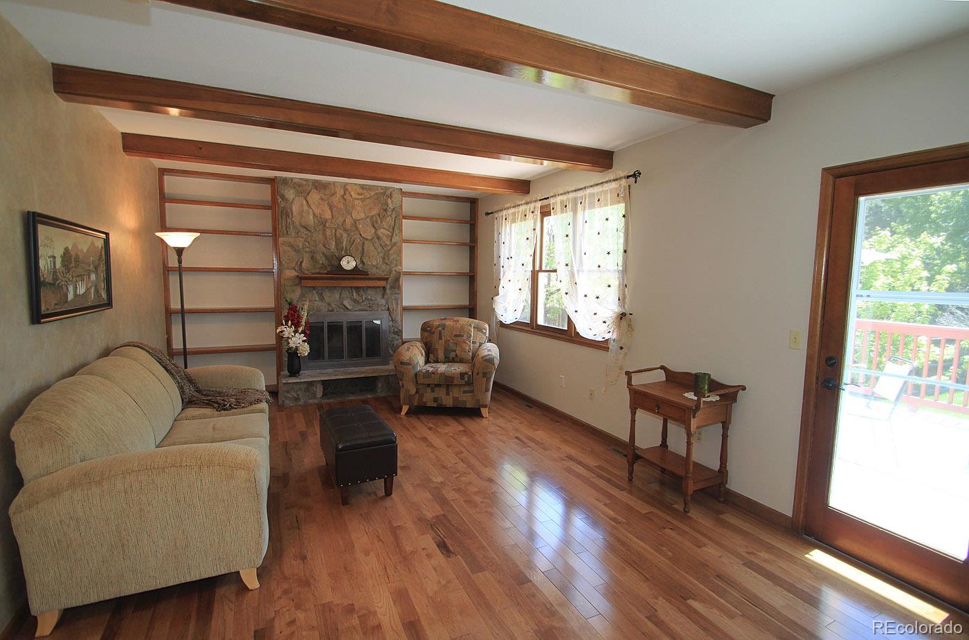 8198 Sweet Water Road Lone Tree, CO 80124 - Photo 7 of 23 a living room with furniture and a wooden floor