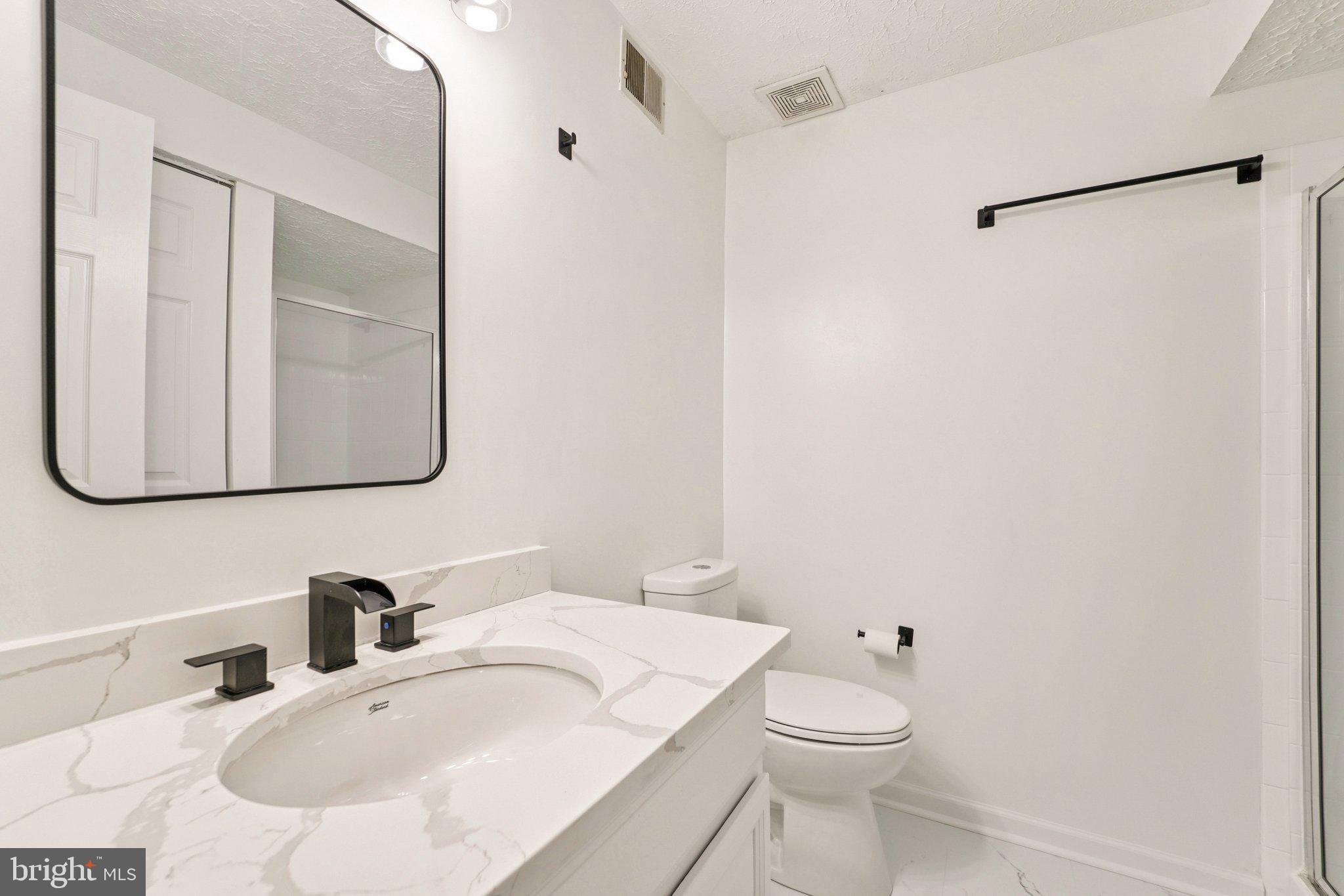 8727 Silver Hall Road Perry Hall, MD 21128 - Photo 22 of 35 a bathroom with a sink and a mirror