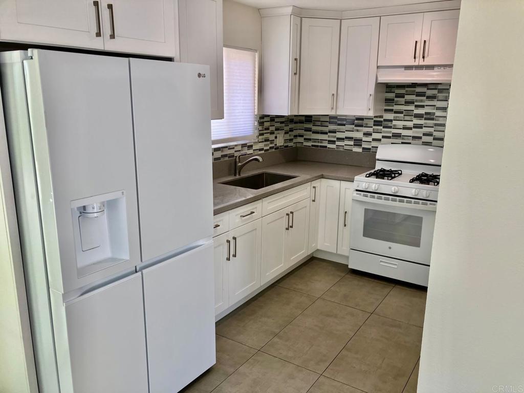 a kitchen with cabinets and appliances