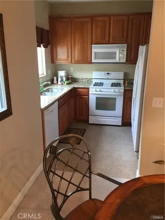 a view of a patio with couches table and chairs and potted plants