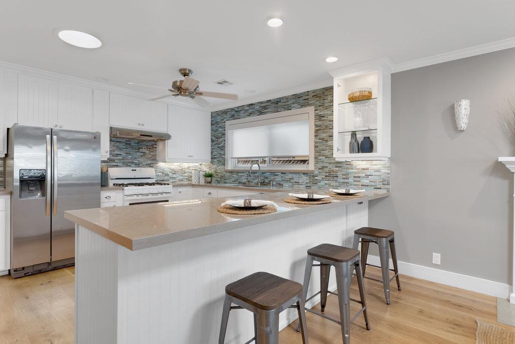 114 Bennett Road Aptos, CA 95003 - Photo 11 of 37 a kitchen with stainless steel appliances a sink and cabinets