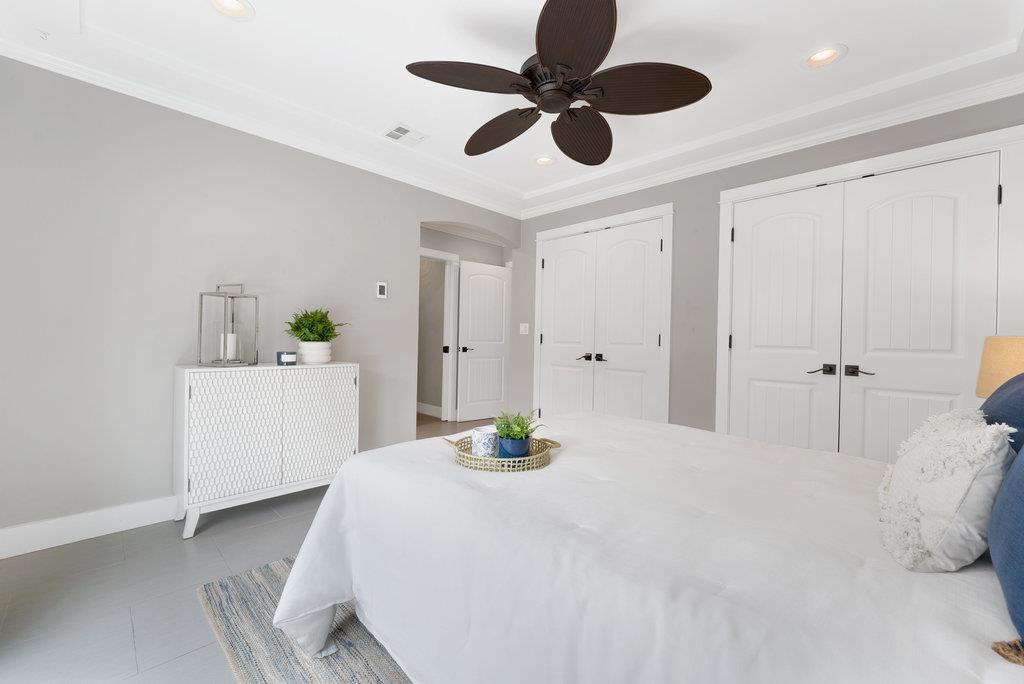 114 Bennett Road Aptos, CA 95003 - Photo 18 of 37 a bedroom with a bed and a chandelier