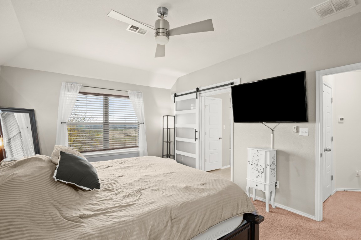 1006 Chad Loop Round Rock, TX 78665 - Photo 14 of 26 a bedroom with a bed tv and a window