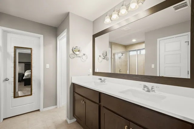 a bathroom with a double vanity sink and a mirror