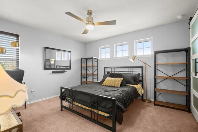 a bedroom with a bed window and a couch