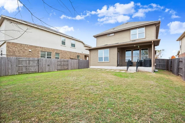 a view of a house with backyard and porch
