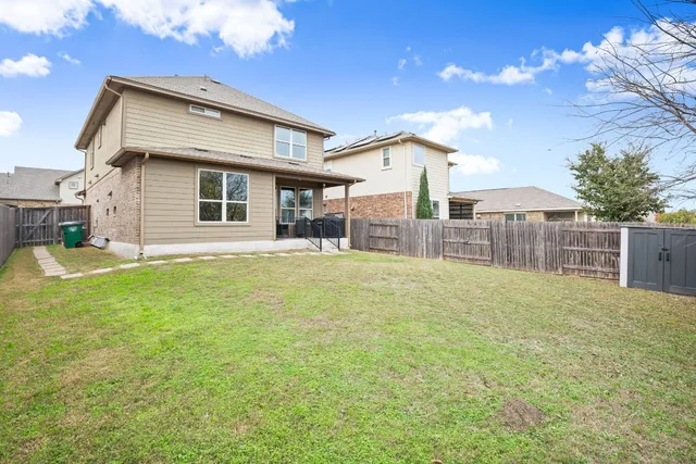 a backyard of a house with table and chairs