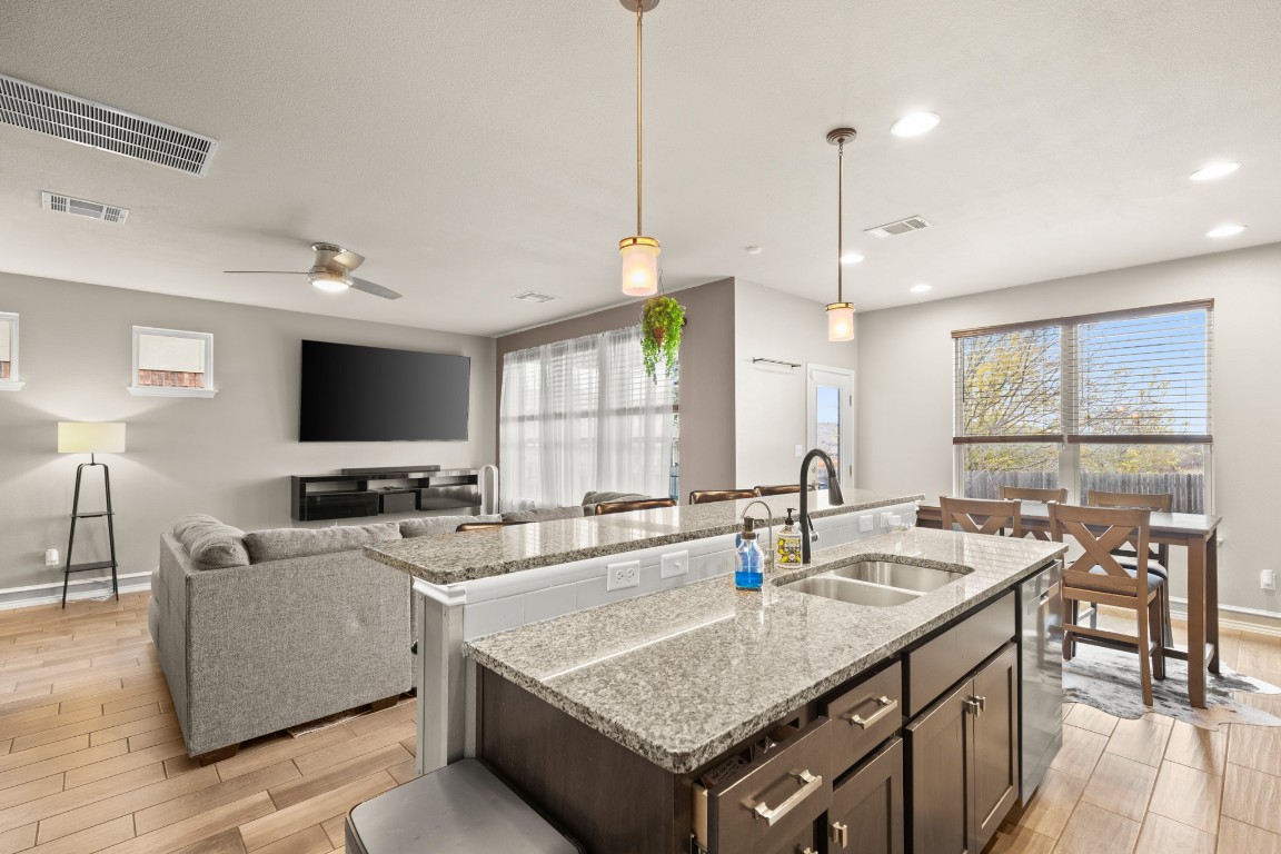 1006 Chad Loop Round Rock, TX 78665 - Photo 6 of 26 a kitchen with granite countertop a sink a counter top space and living room view