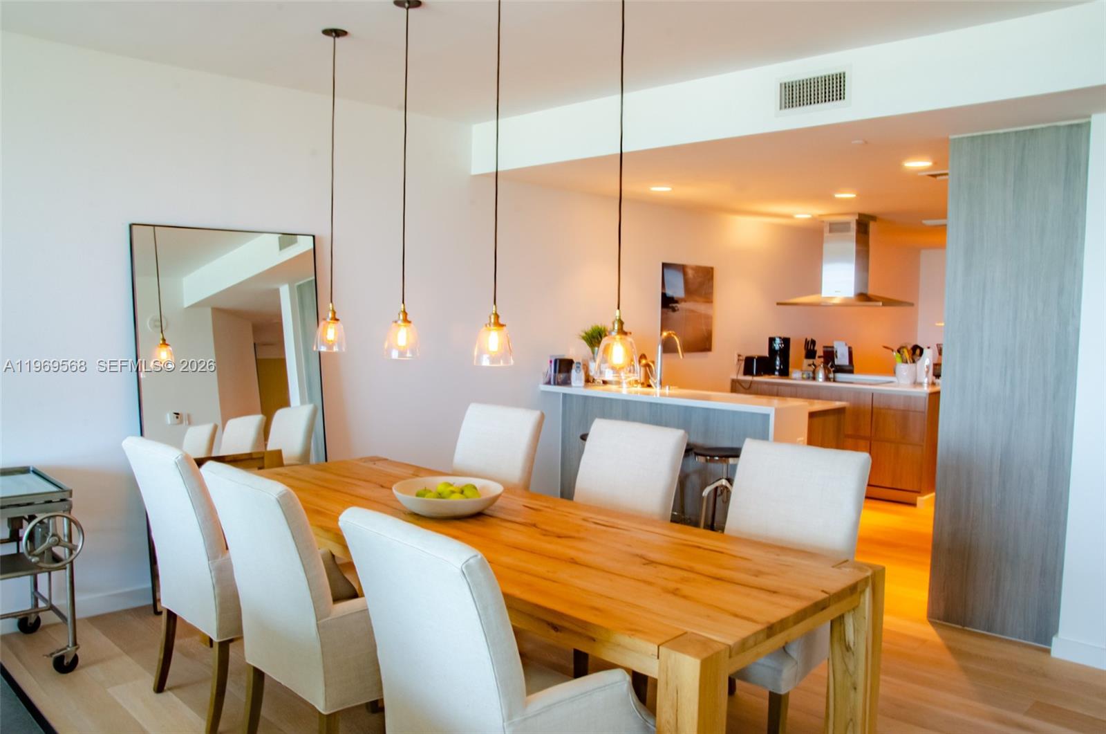 350 Ocean Drive, Unit 406N Key Biscayne, FL 33149 - Photo 16 of 41 a bedroom with a bed a lamp and wooden floor
