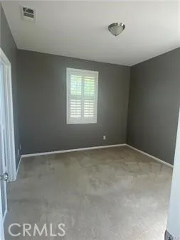 a view of an empty room and a window