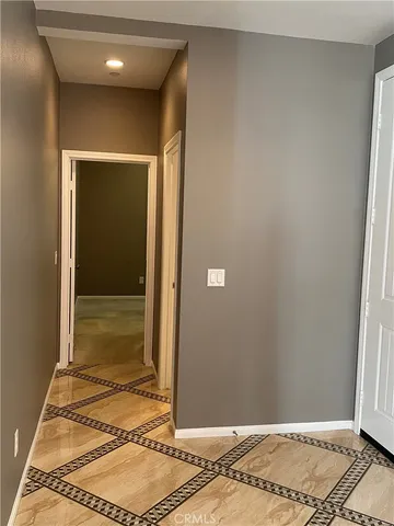 a view of a room with a door and wooden floor