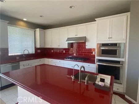 a kitchen with a sink cabinets and window