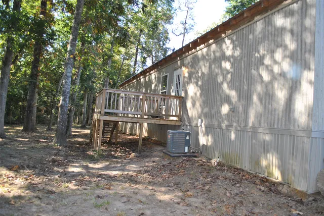 a view of backyard with deck and outdoor seating