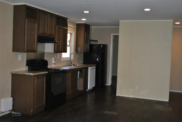 a kitchen with stainless steel appliances granite countertop a refrigerator and a stove top oven