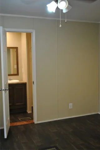 an empty room with wooden floor and closet
