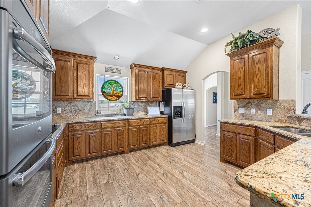 16101 Dove Road Moody, TX 76557 - Photo 10 of 42 a kitchen with granite countertop a sink stainless steel appliances and cabinets