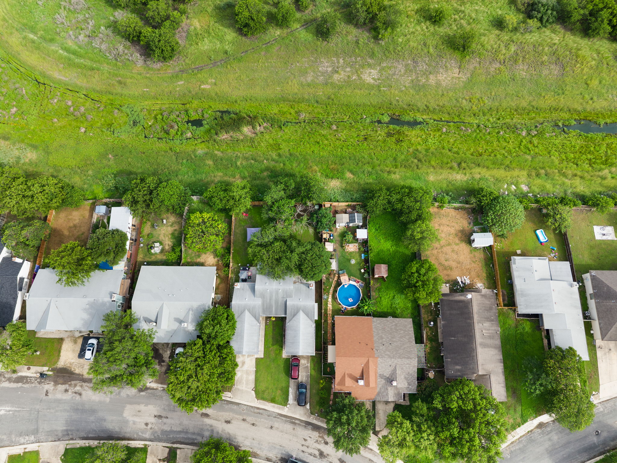 8317 Forest Ridge Drive San Antonio, TX 78239 - Photo 25 of 26 An aerial perspective reveals a vibrant neighborhood with verdant landscaping and backyard pools.