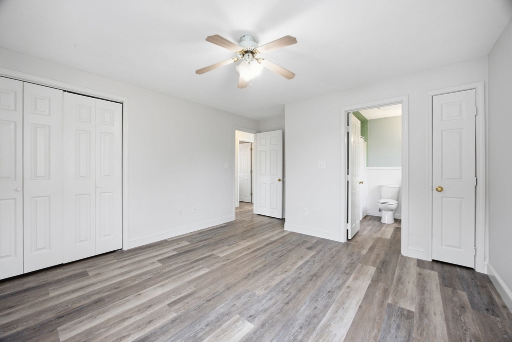 192 Swifts Beach Road Wareham, MA 02571 - Photo 31 of 38 an empty room with wooden floor and a ceiling fan