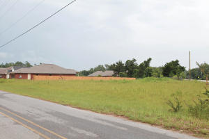 3855 Adams Road Pace, FL 32571 - Photo 1 of 1 a view of a lake with houses in the back