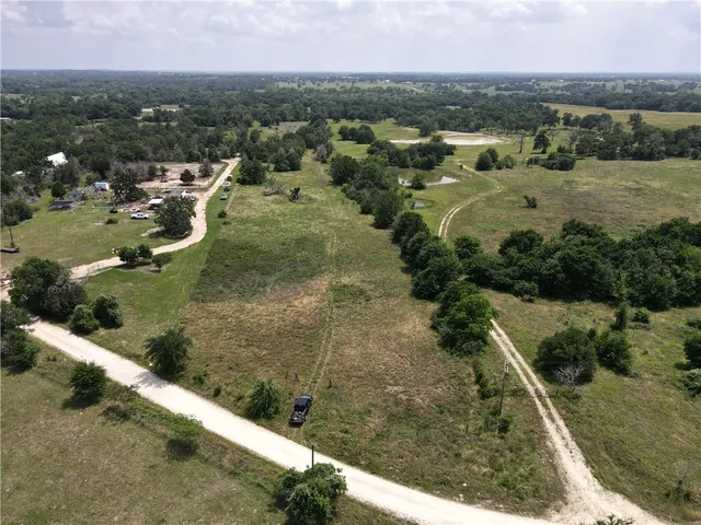 a view of a field of grass and trees