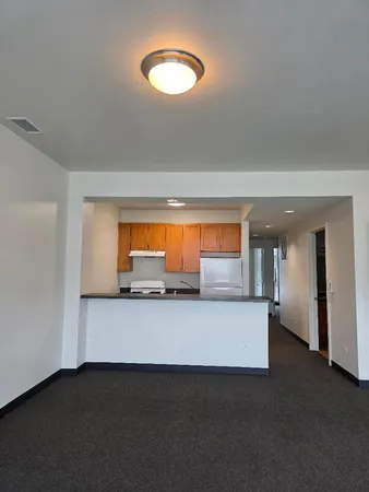 a kitchen with a sink and a mirror