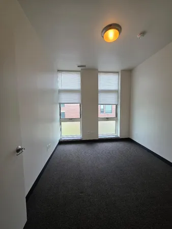 a view of an empty room with a fireplace